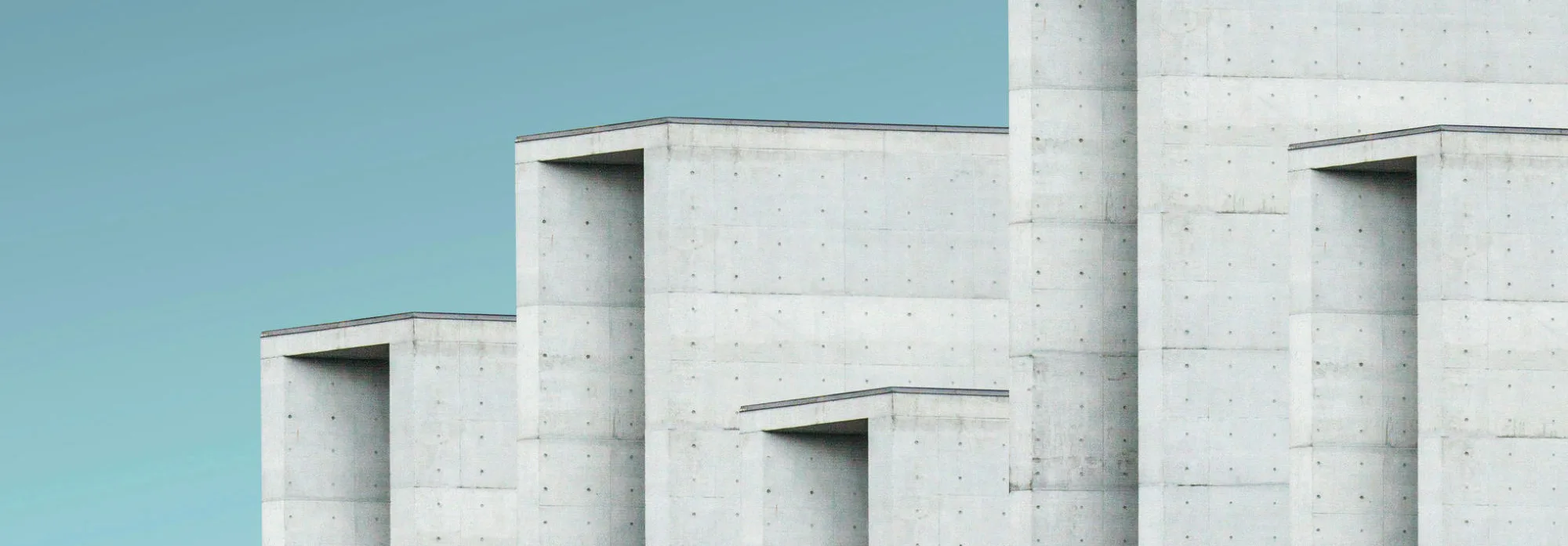 Minimal concrete architecture under a blue sky